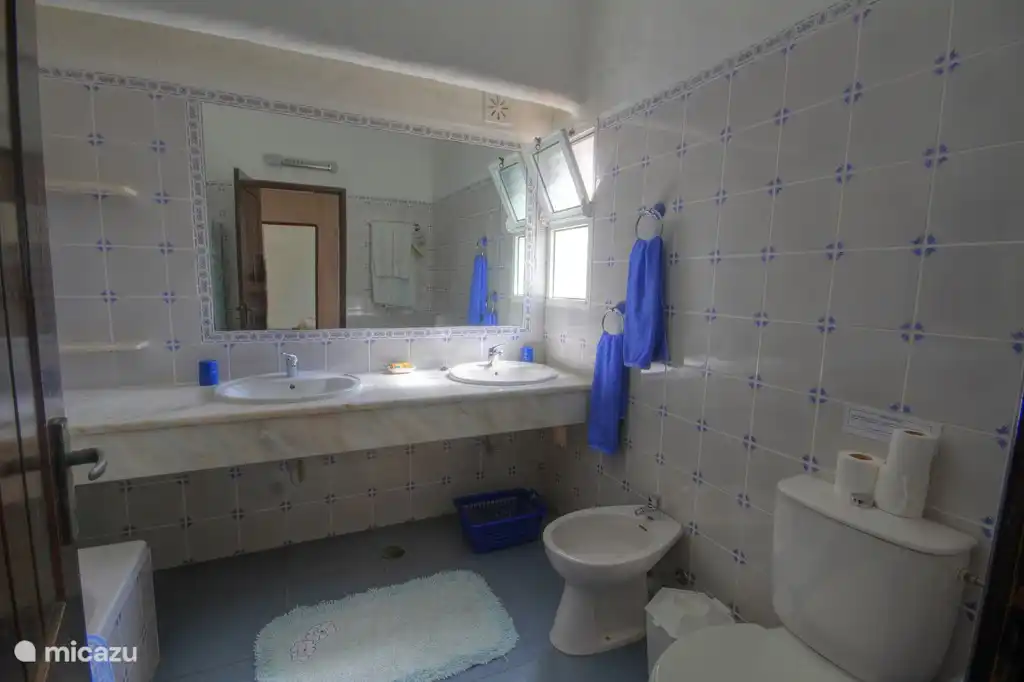 2 bathroom with bath, shower, basin and bidet.