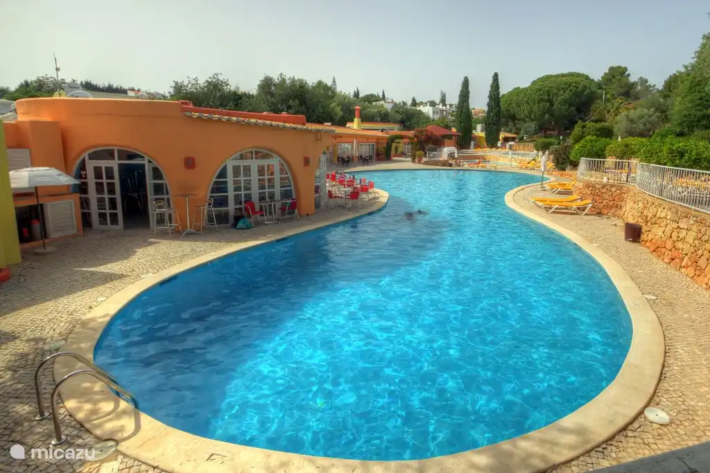 One of the three pools with cozy bar, lounge chairs and parassols.