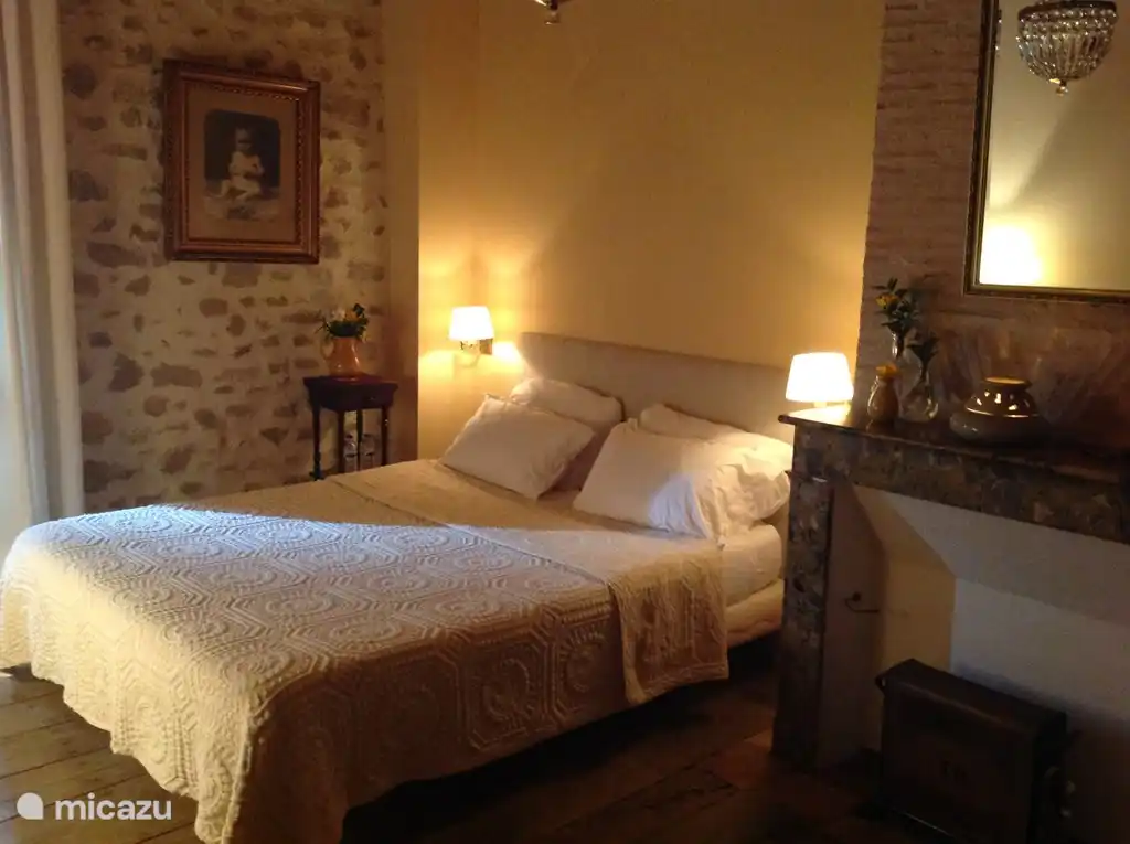 Large 2-person bedroom with seating, spacious wardrobe and view of the pool.