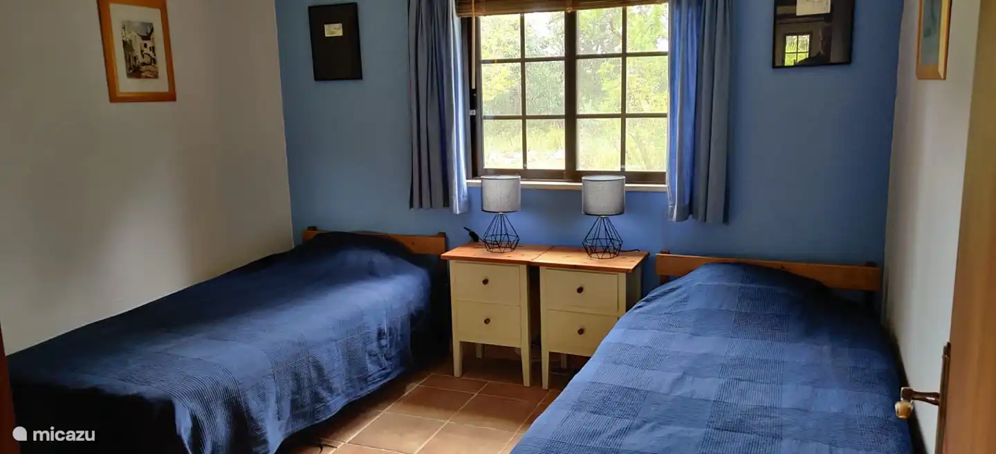 the lavender bedroom with 2 single beds