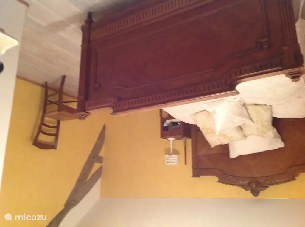 The yellow bedroom with a double bed