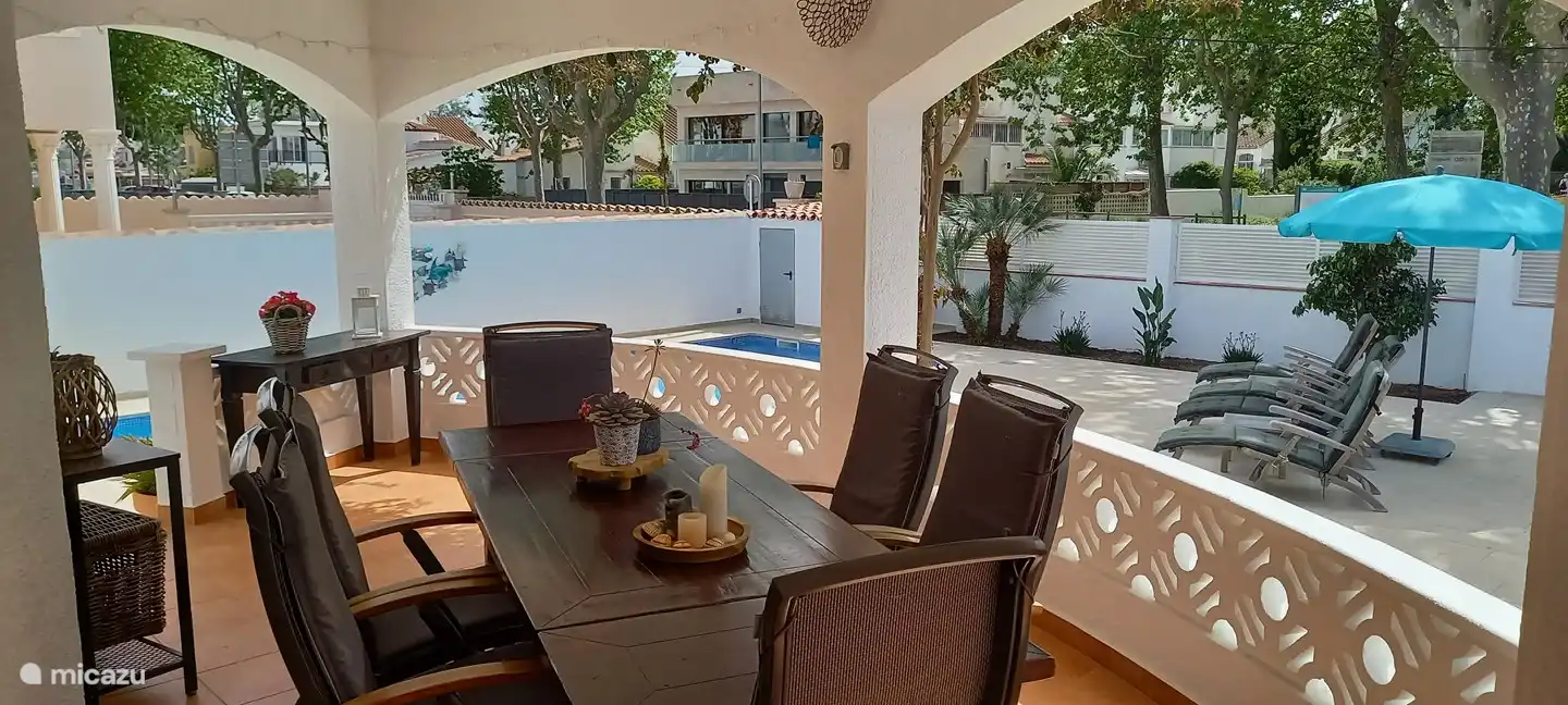 Covered terrace overlooking the garden and park opposite (with play area).