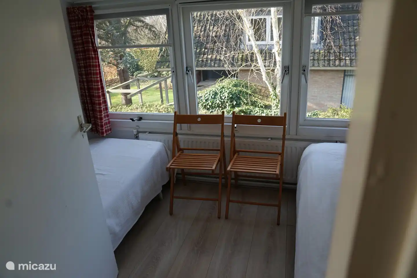 Smallest bedroom with two beds on either side.