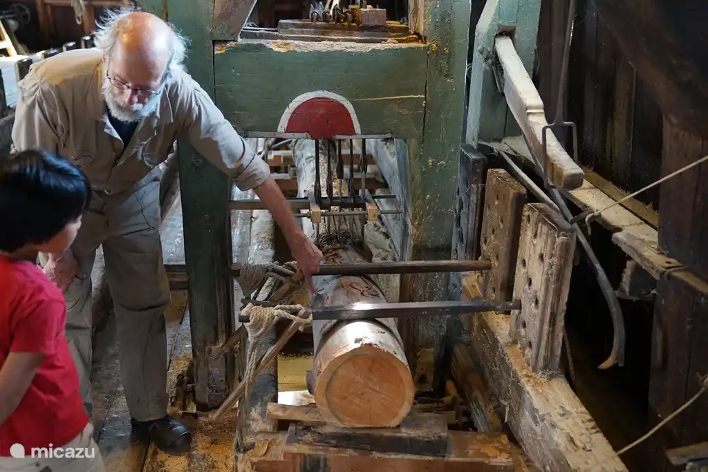 The miller of the sawmill in Woudsend explains to our son about the working of the saw. Every Saturday the mill is open to the public.