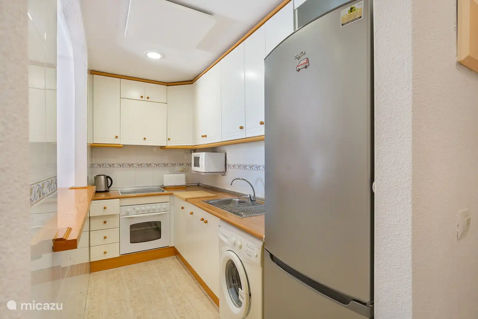 There is a spacious refrigerator with separate freezer.