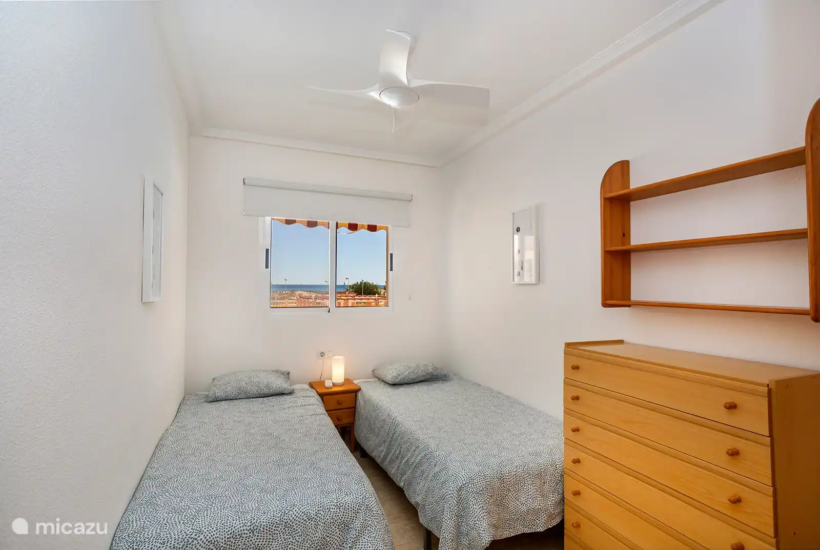 The second bedroom. Here too, a fan hangs from the ceiling.