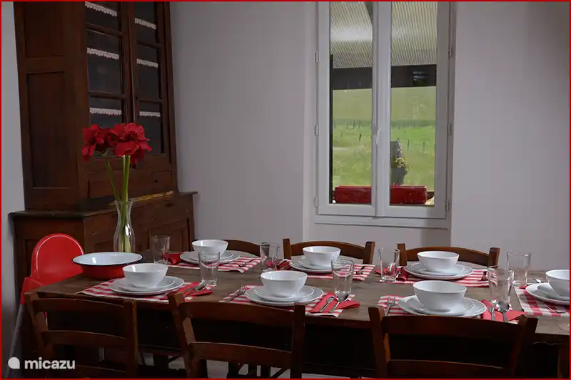 Large dining table. tableware is present in excess.