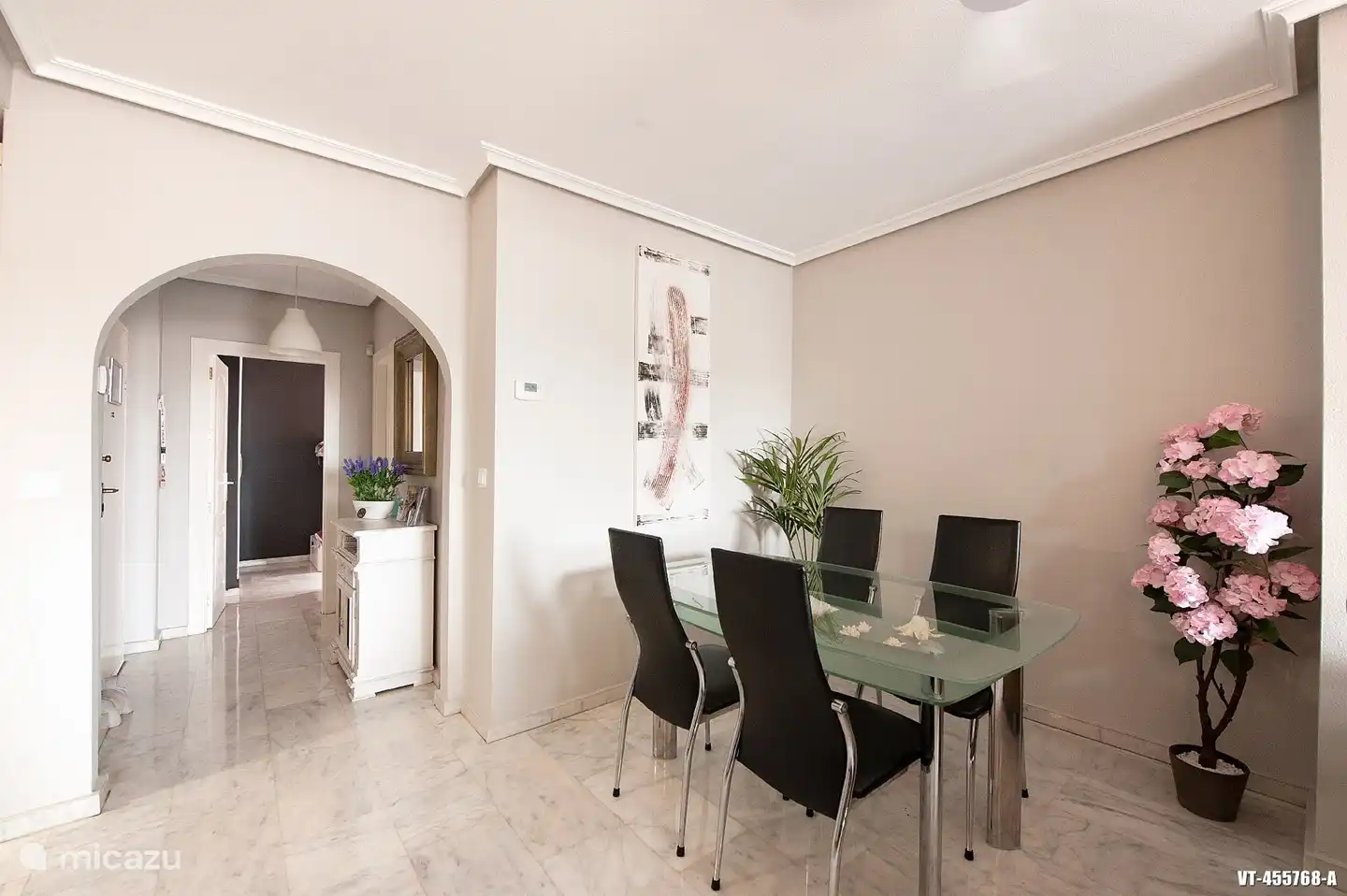 Eethoek voorzien van glazen designtafel met 4 lederen stoelen.