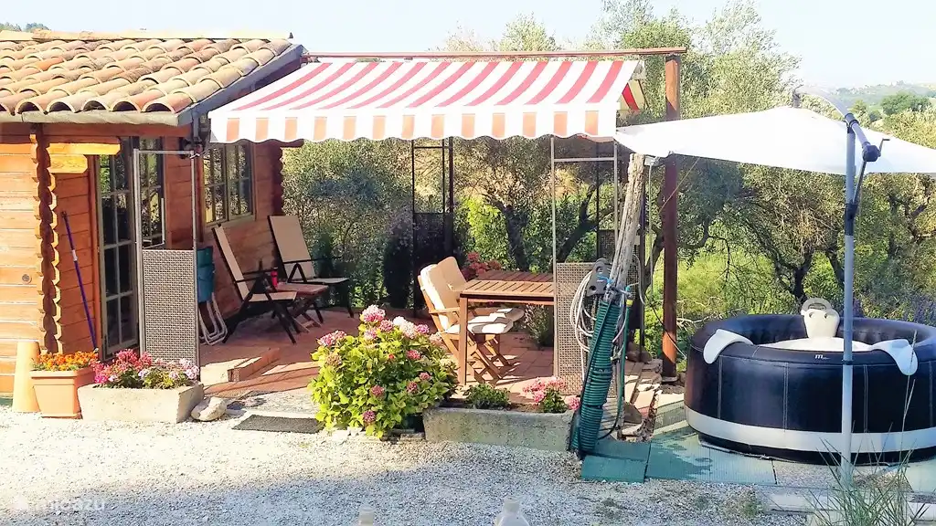Spacious well covered terrace WITH Jaccuzzi in front of the door.