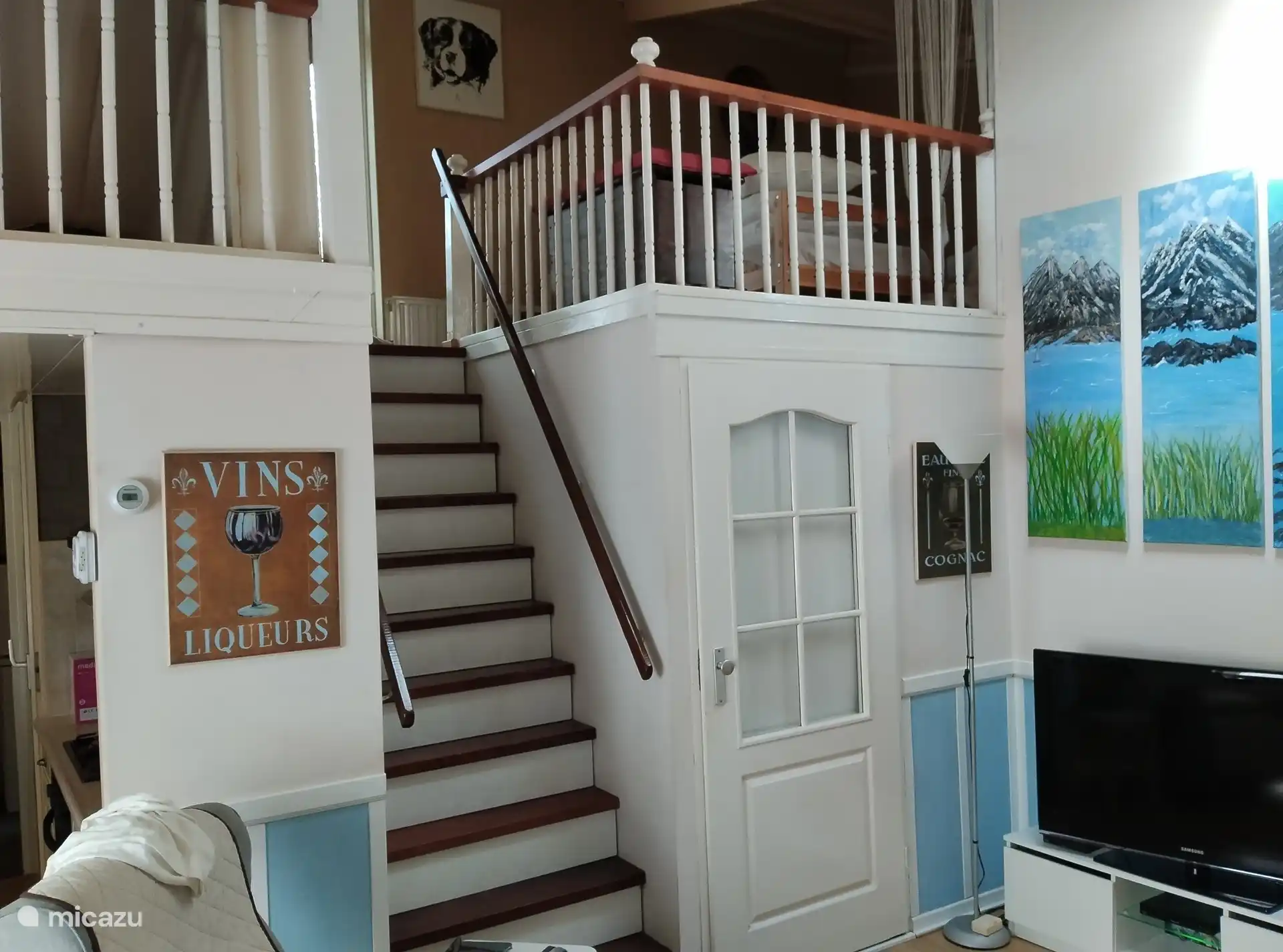 entrance to the mezzanine.
Here are 2 single beds and there is a sitting area with table