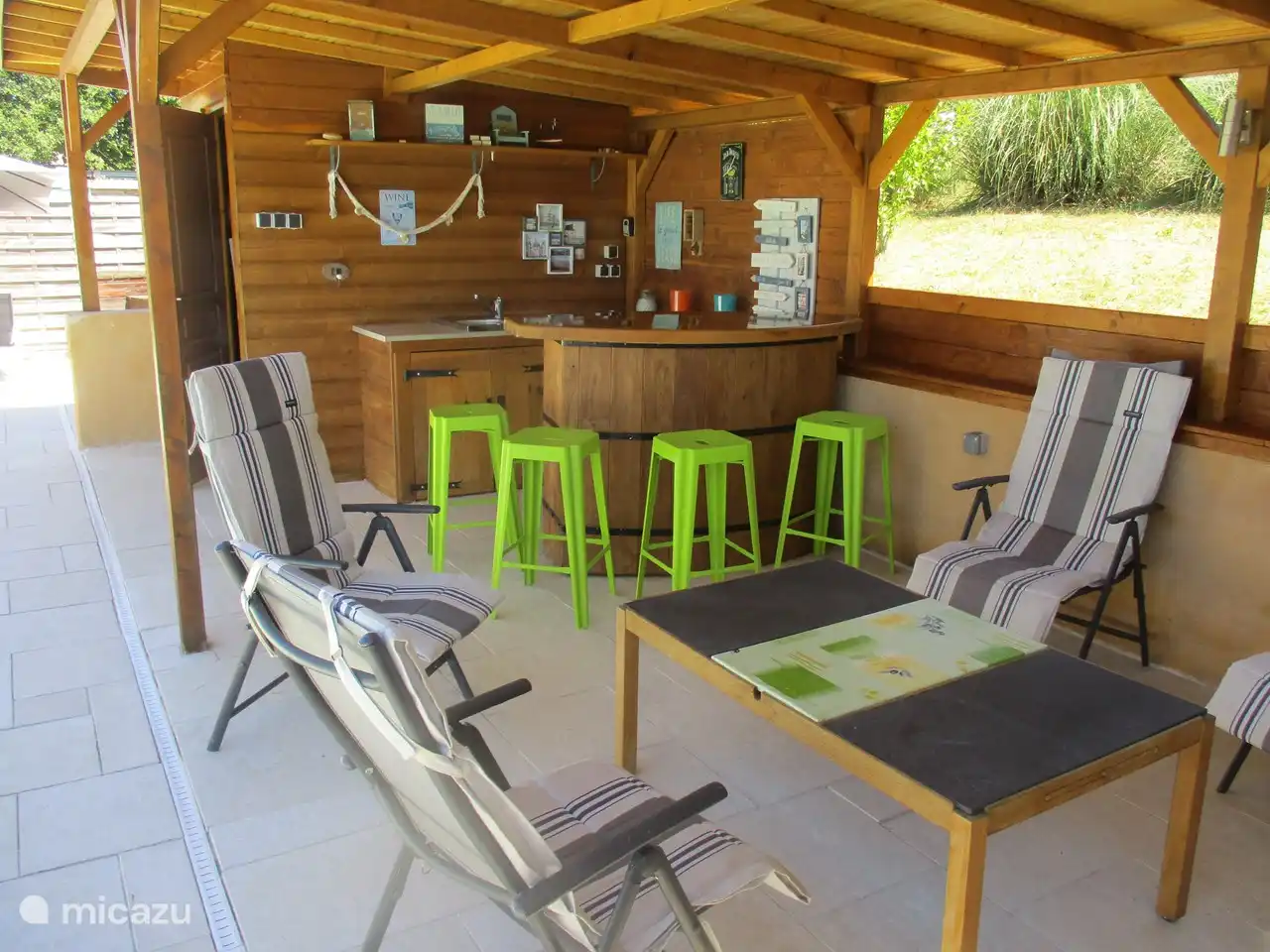Pool house with bar and refrigerator and ice cube machine