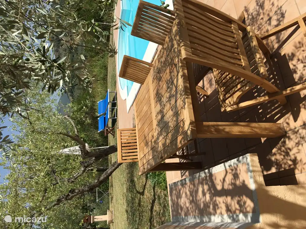 Terrace by pool with dining area