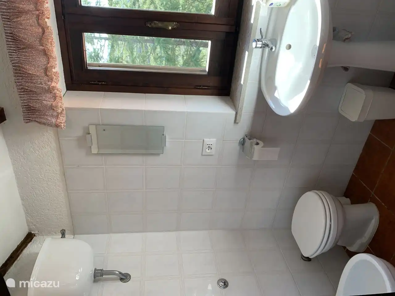 Bathroom 2 located on the first floor. Equipped with toilet, bidet, sink and shower with shower doors.