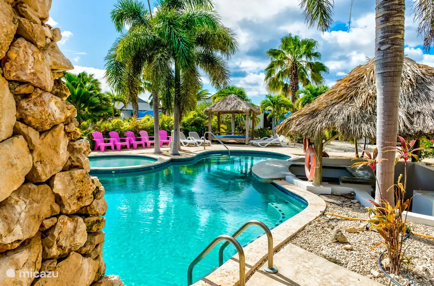 The pool has a waterfall and plenty of opportunities for sunbathing and swimming.