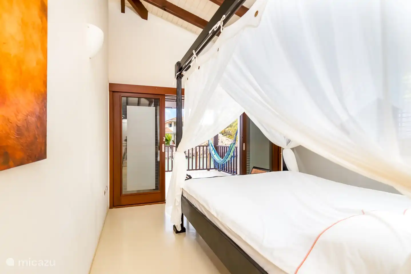The first bedroom has a kingsize four-poster bed