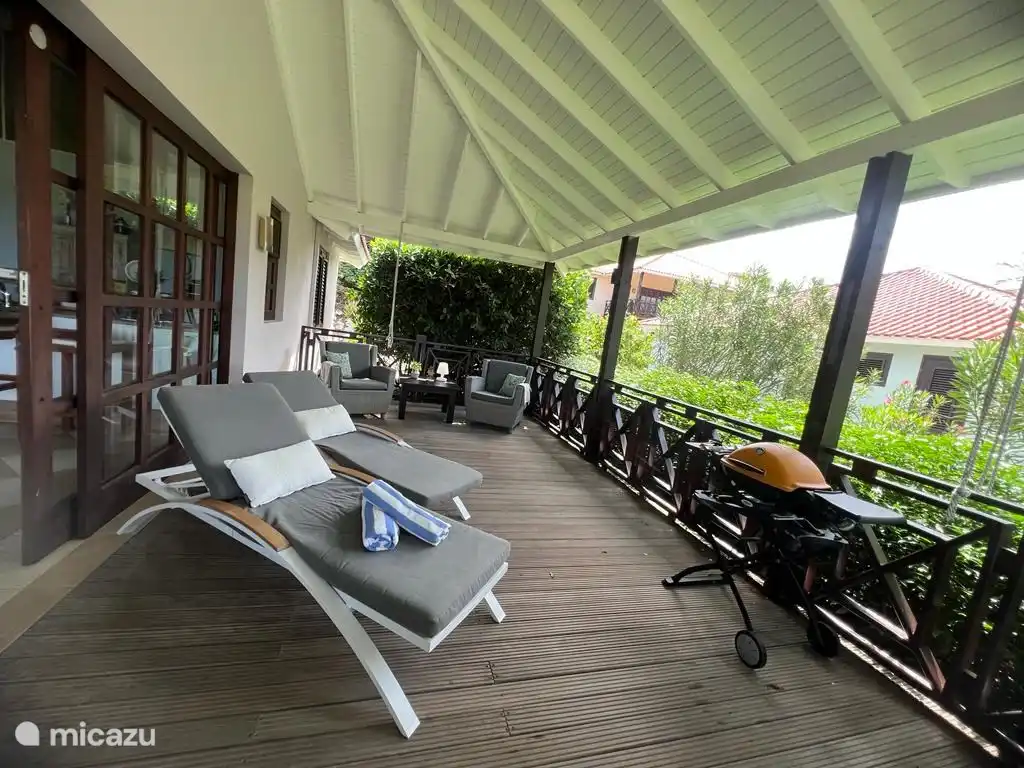 Porch with sunbeds and hammock