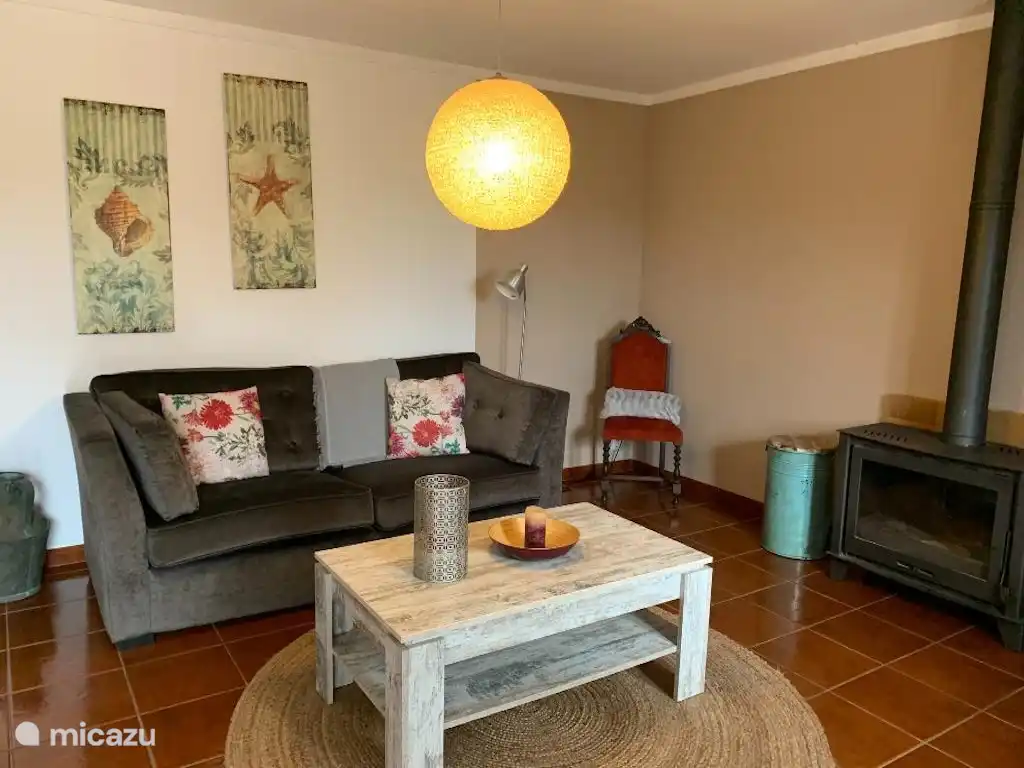 Living room with wood burning stove for the winter months. TV and internet.