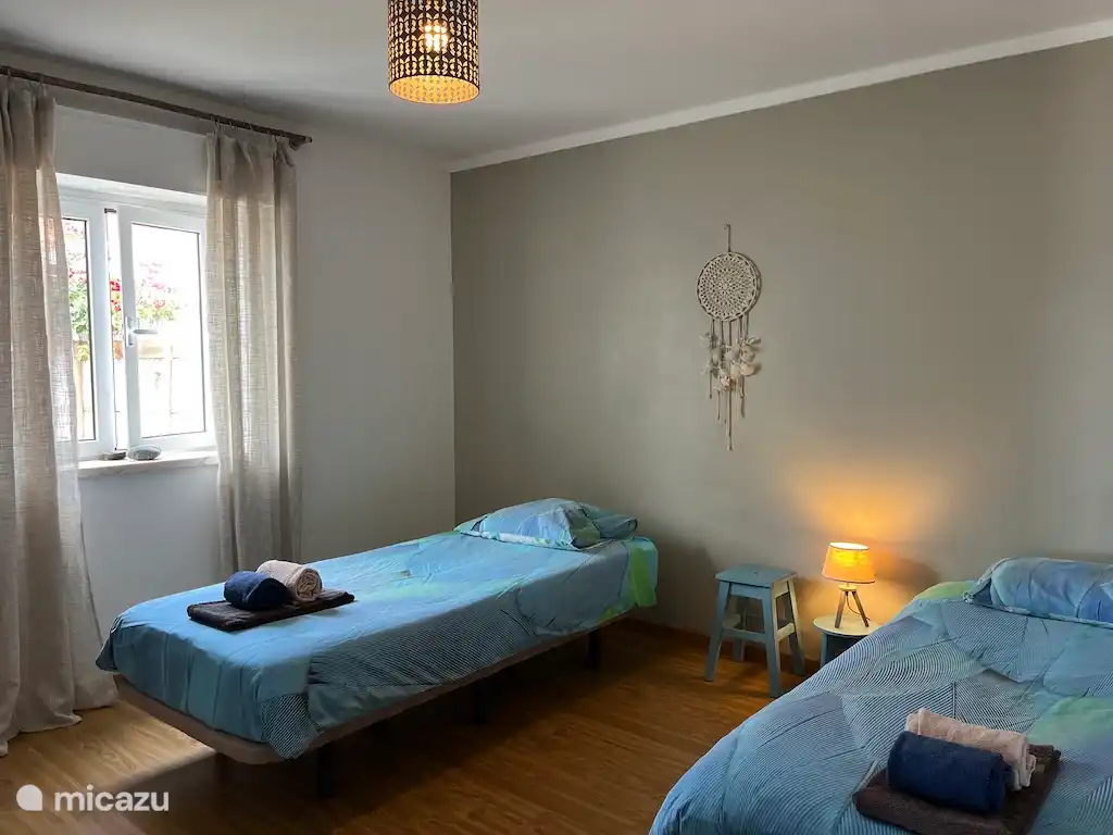 2nd bedroom with 2 single beds and wardrobe.