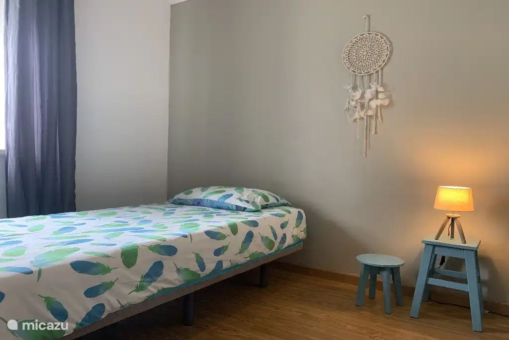 Bedroom with 2 single beds and wardrobe.