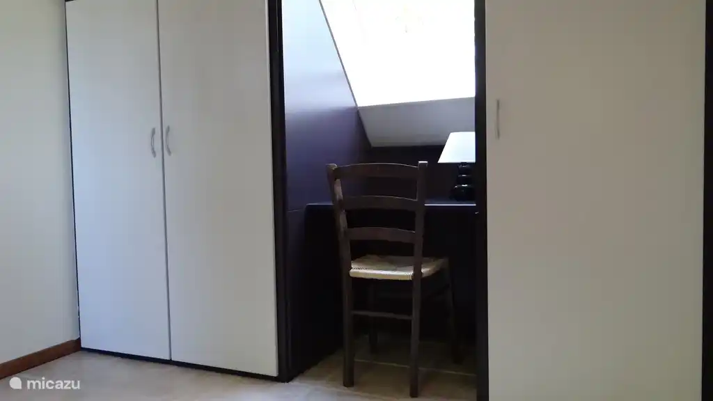 Zweites Schlafzimmer im Obergeschoss: Kleiderschrank und Schreibtisch