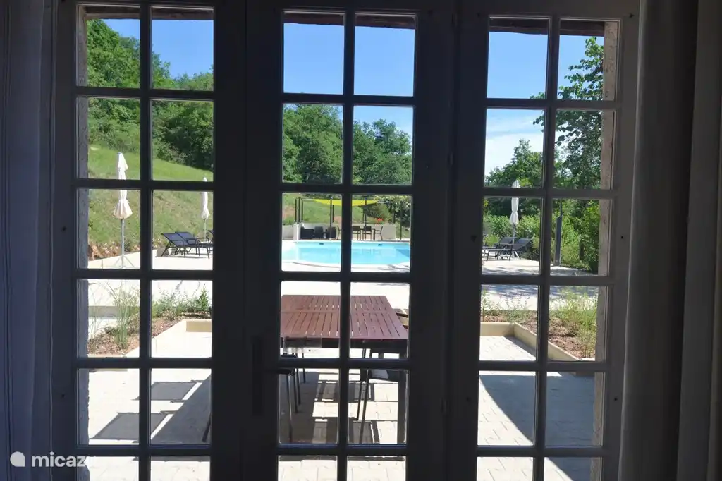 View of the terrace and the swimming pool from the living room