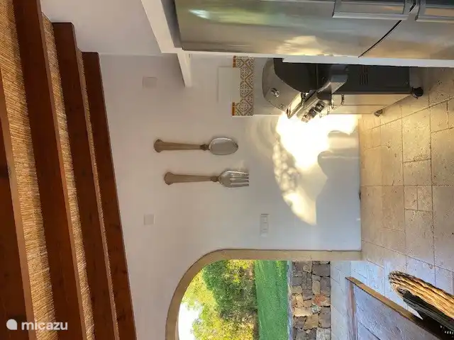 The covered outdoor kitchen is ideally located on the south, with a view over the garden and of course directly at the pool, outdoor shower and toilet.