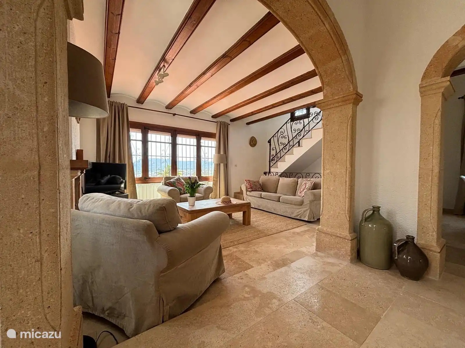From the living room the stairs go up to the master bedroom and down to the swimming pool and outdoor kitchen.