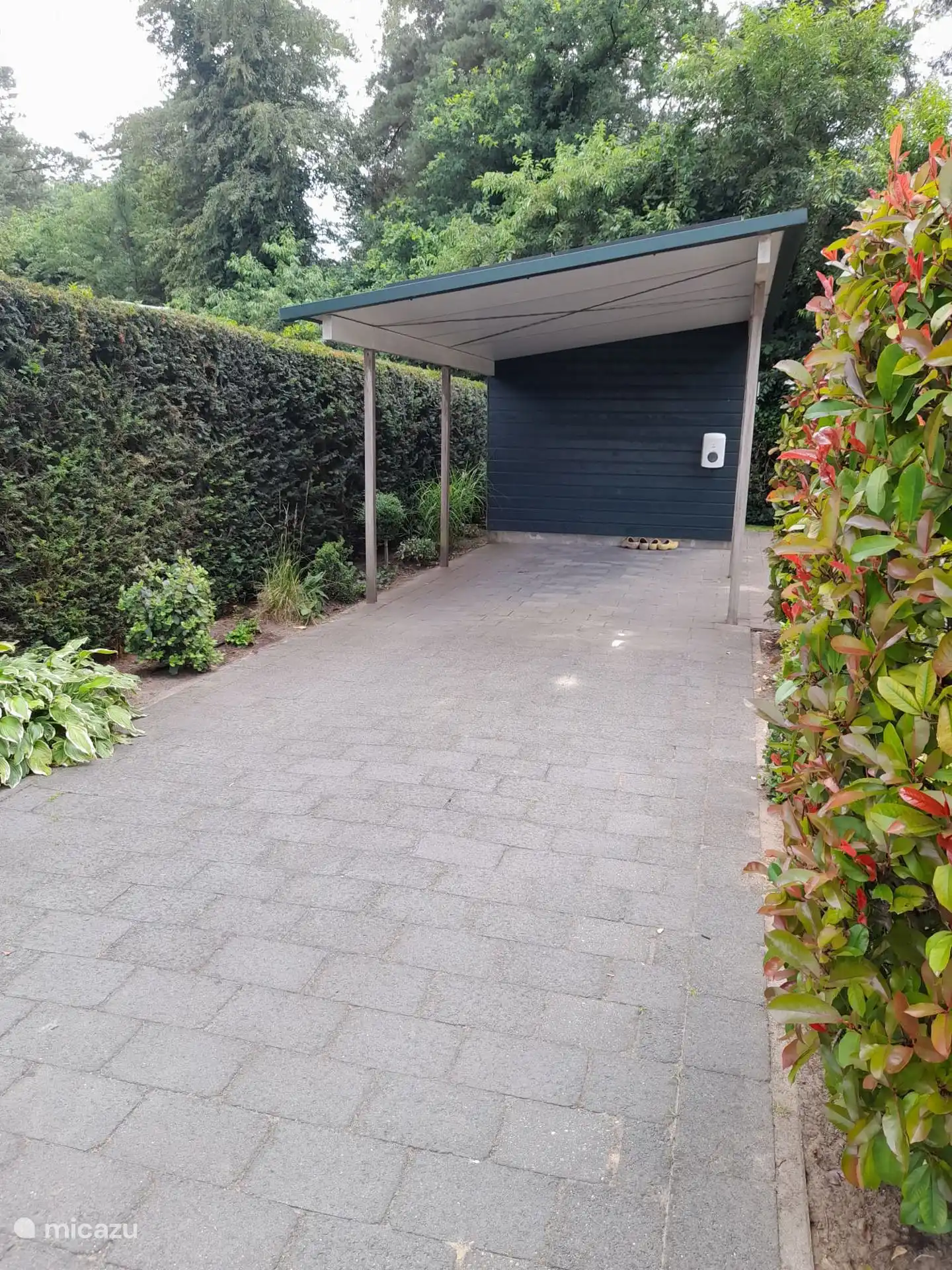 Bungalow 4 has a spacious driveway with carport and a shed where you can park the bicycles.  There is also a charging station for the car.