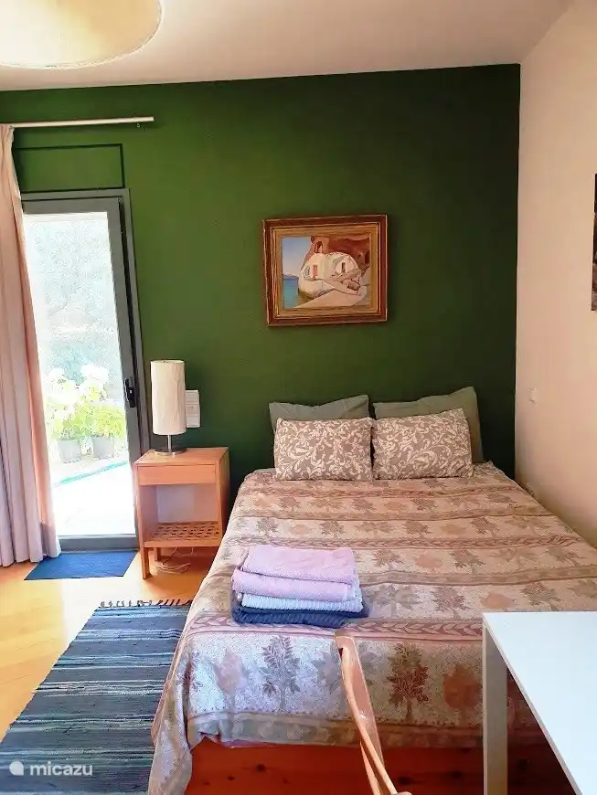 The cozy double bed of the apartment.