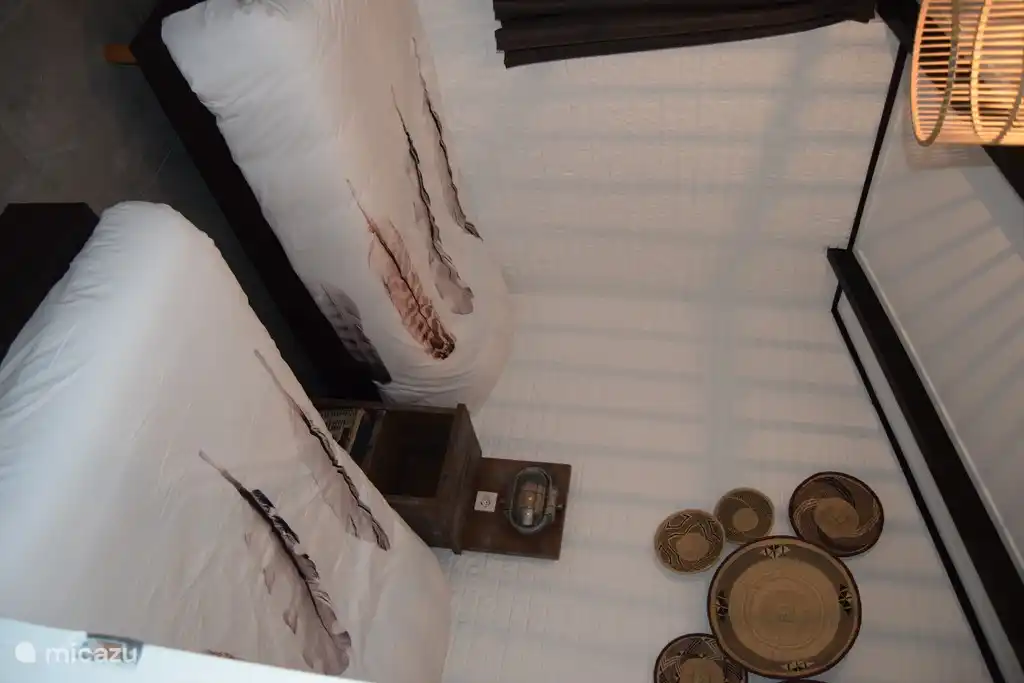 cozy bedroom with box spring beds and wardrobe