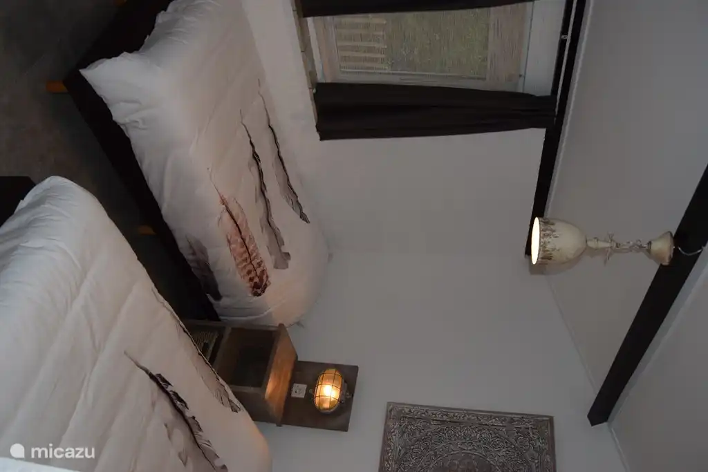 cozy bedroom with box spring beds and wardrobe