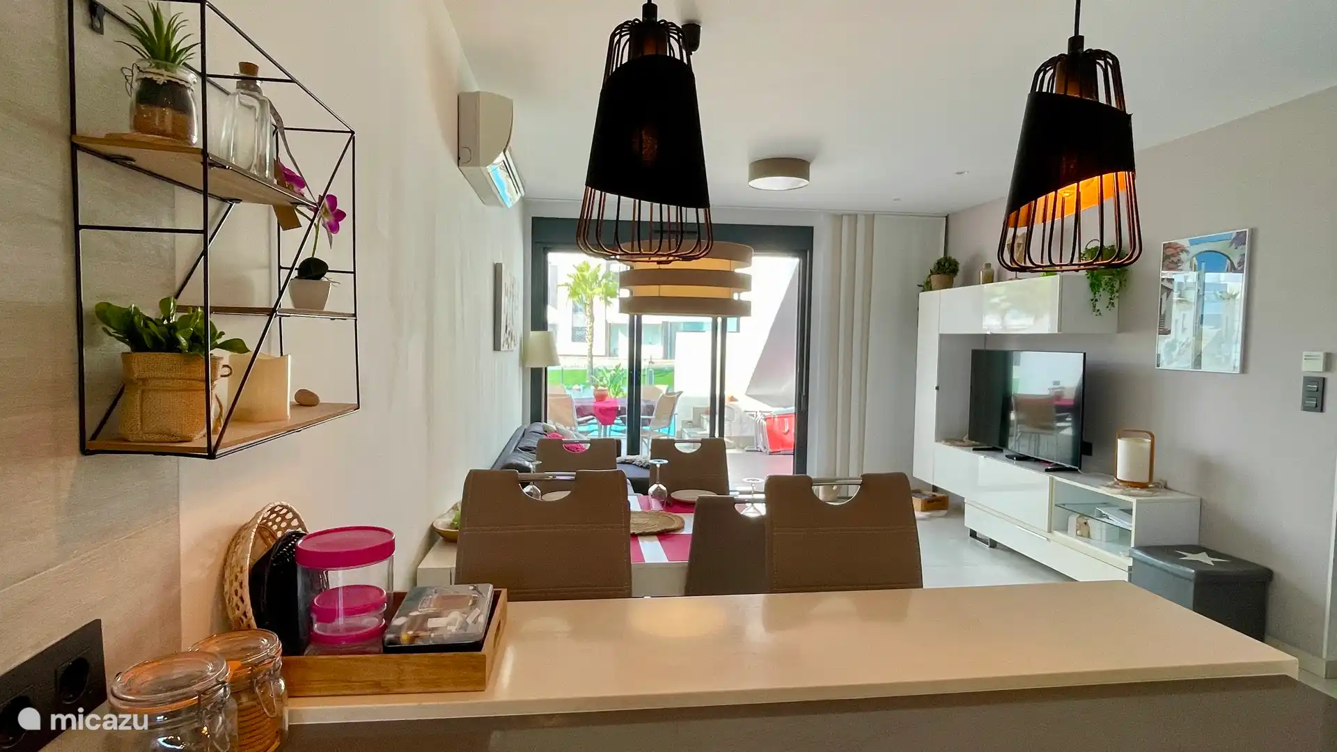 The living room with cozy bar and dining table from the open kitchen.