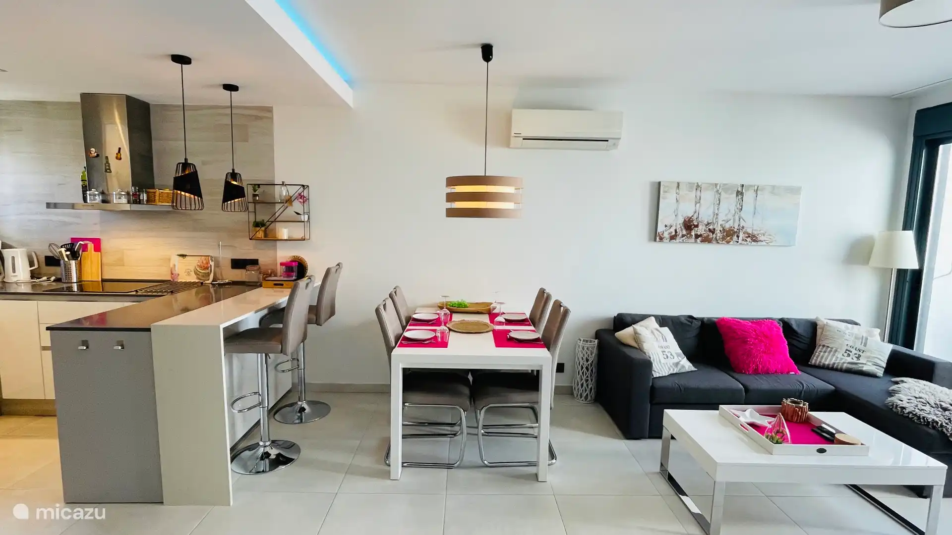 The living room with extendable dining table, bar and lounge / sofa bed. 