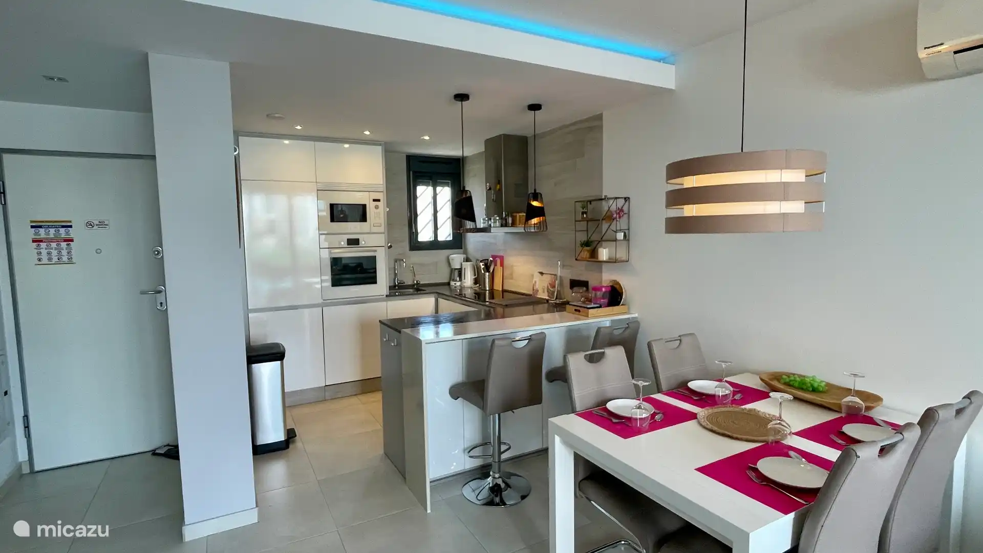 The open kitchen with Bosch built-in appliances and cozy bar. Cheers!!