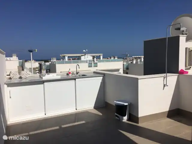 Penthouse Casa Esmeralda | Espagne, Costa Blanca, Torrevieja - appartement Solarium avec cuisine extérieure et douche. Il y a aussi un grand parasol au-dessus de la table à manger.