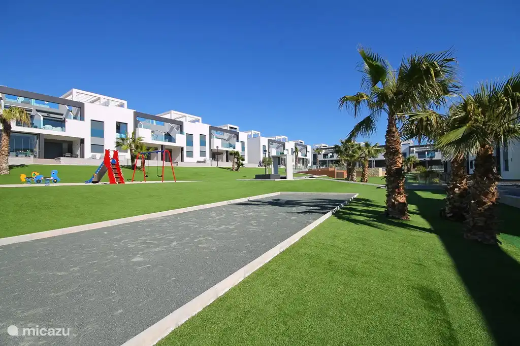 Garden with Jeu de Boules court, children&#39;s playground and sandpit.