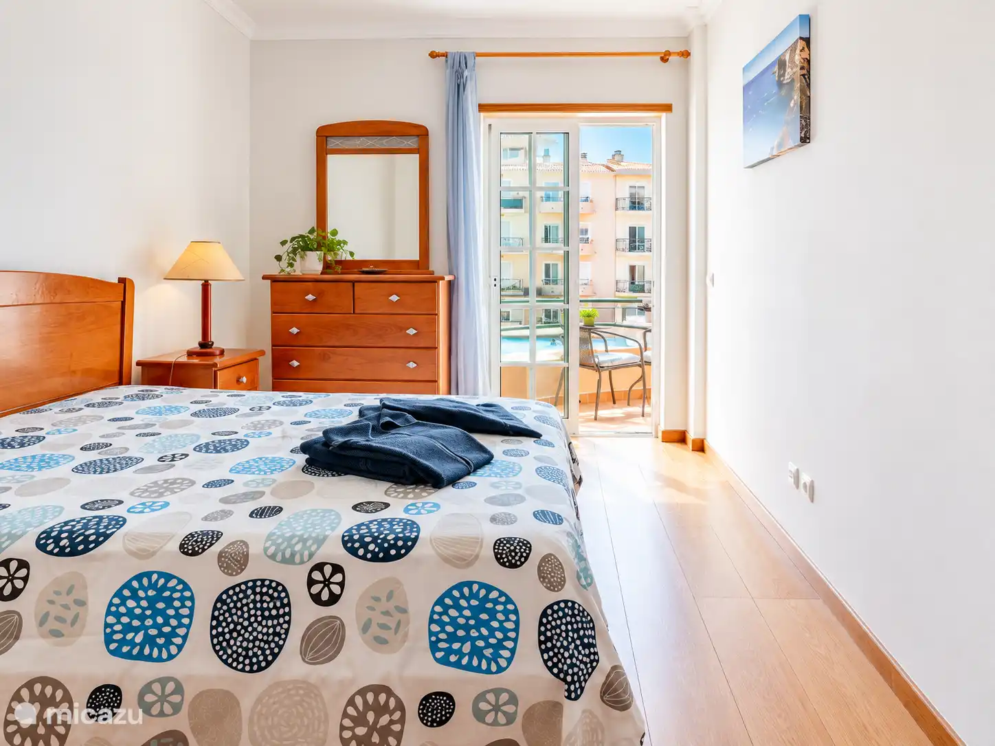 Erstes Schlafzimmer mit Zugang zur Sonnenterrasse und Blick auf den Pool