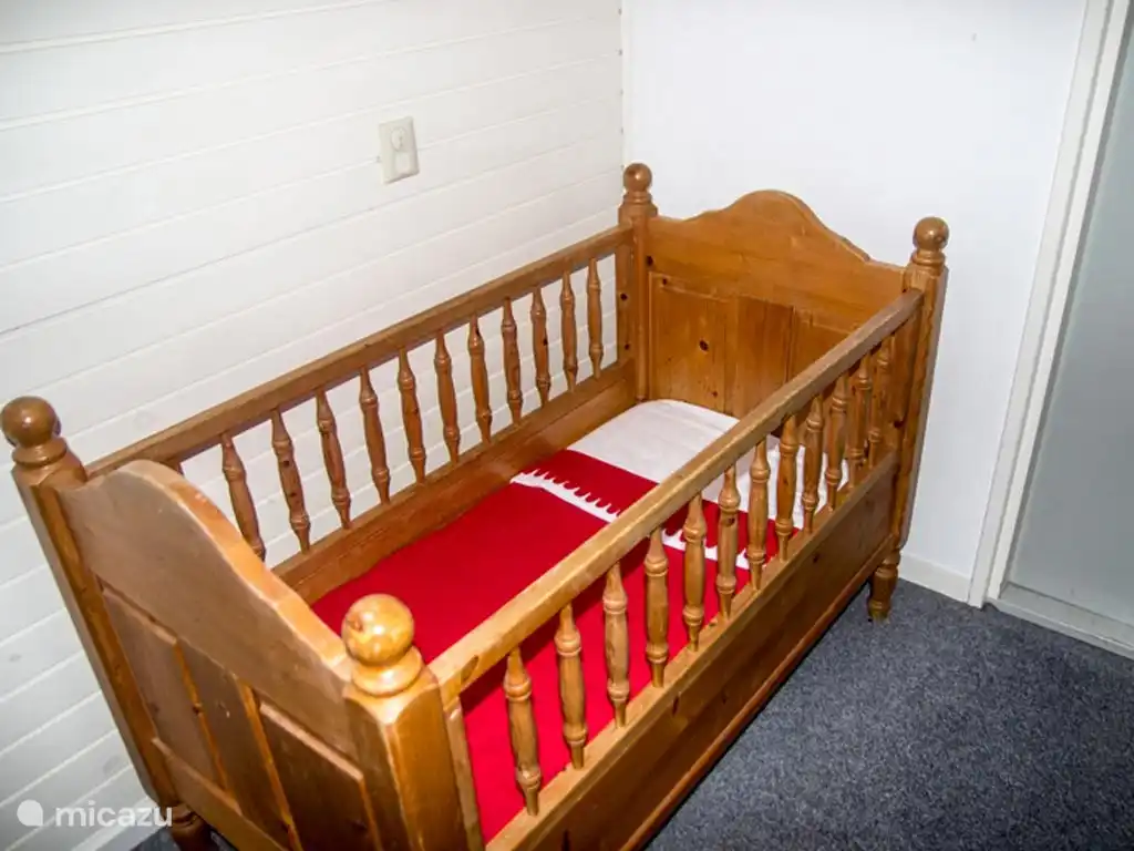 There are two cots and a playpen.