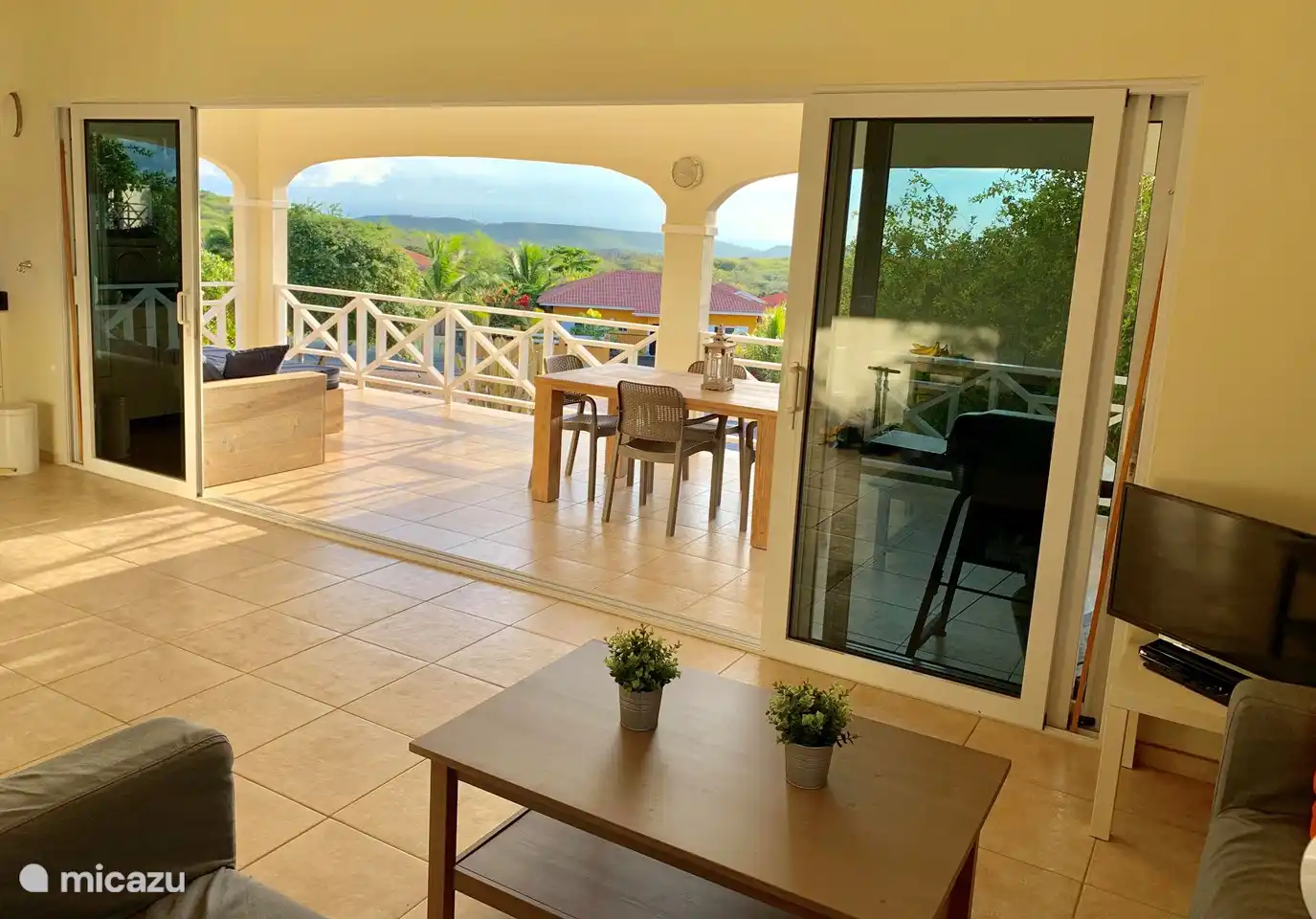 Living room with open kitchen, adjacent to the terrace, with the open kitchen on the left (out of view). . From the terrace you can easily reach the swimming pool.