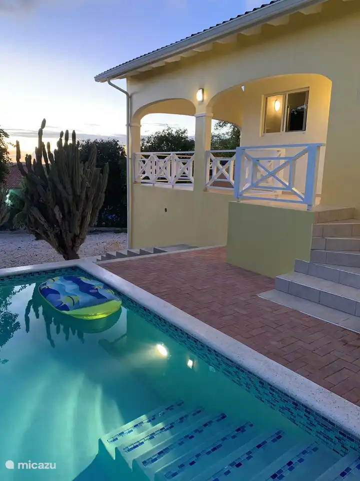 Swimming pool with privacy is next to the house
