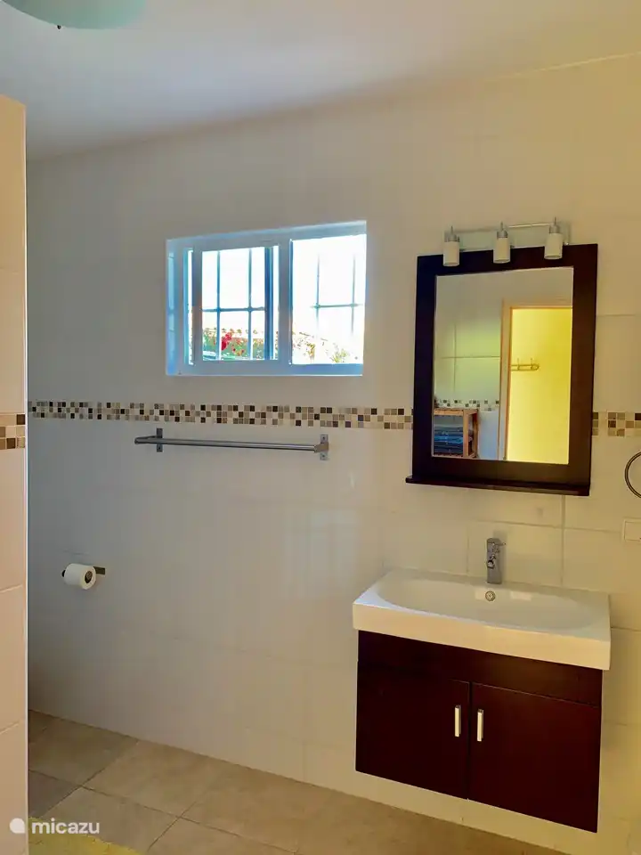 Spacious bathroom with beautiful sink, spacious shower (with hot water) and toilet. There is an extra guest toilet in the living room.