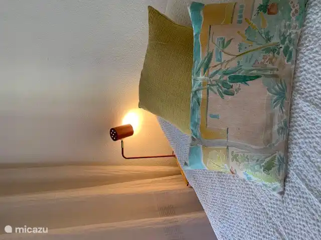 Box spring beds . Master bedroom has patio doors leading to the terrace and garden.