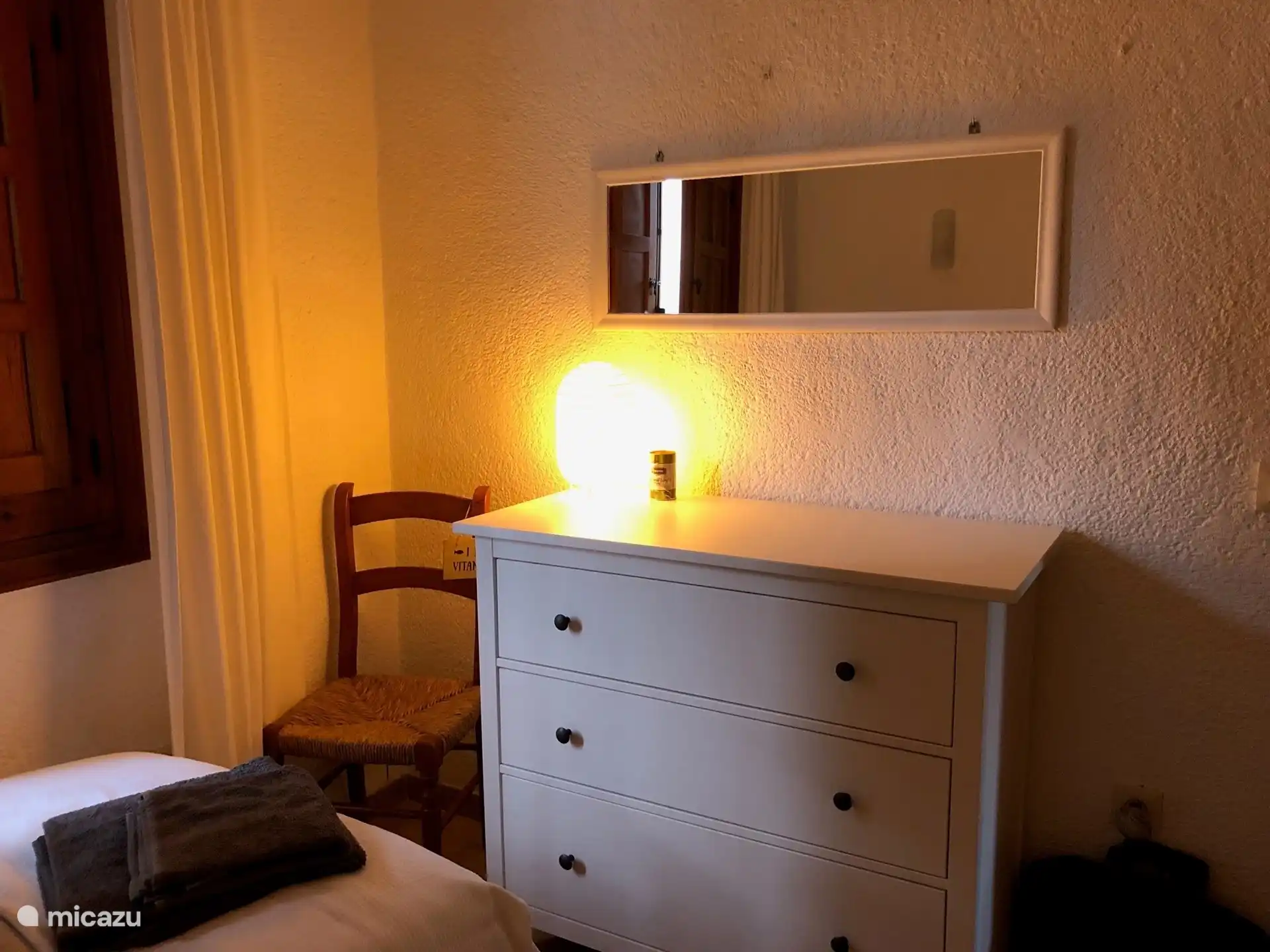 Bedroom 2 with air conditioning, mosquito nets and shutters, 2 single beds, chest of drawers and hanging cupboard.