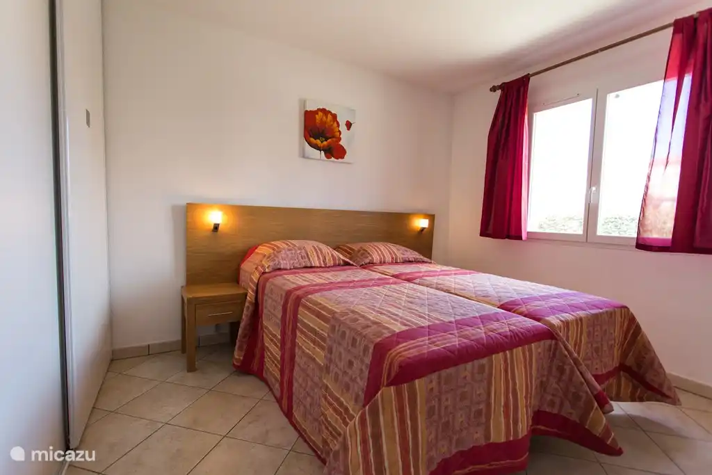 Spacious bedroom with large sliding door wardrobes