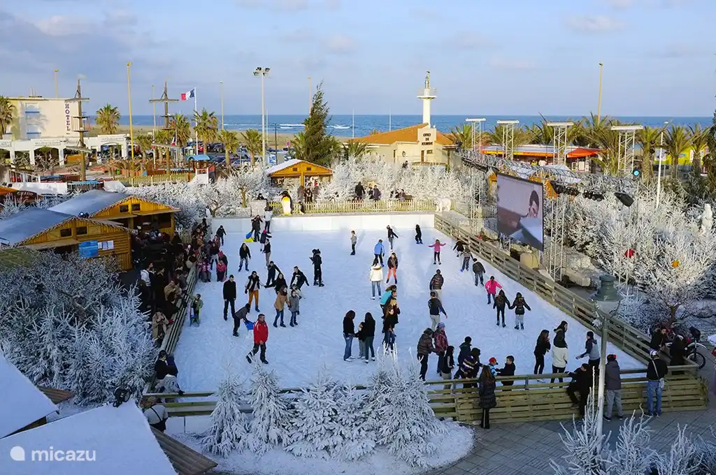 Skating children on the artificial ice rink built around Christmas and New Year in the center of Le Barcarès