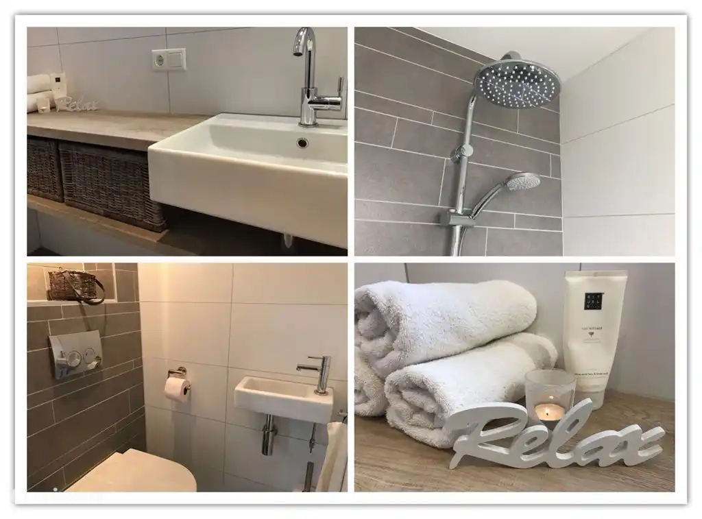 Das Badezimmer verfügt über eine ebenerdige Dusche mit Regendusche.