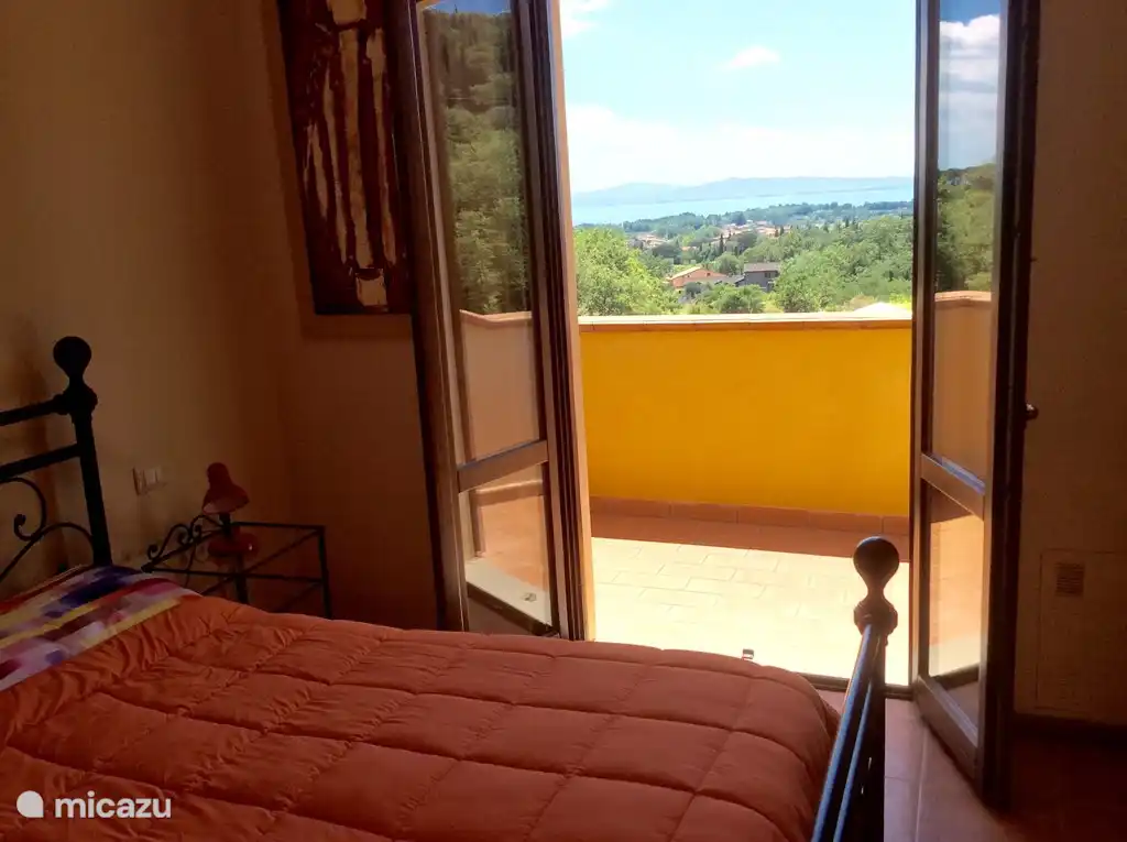 Bedroom with balcony overlooking the lake.