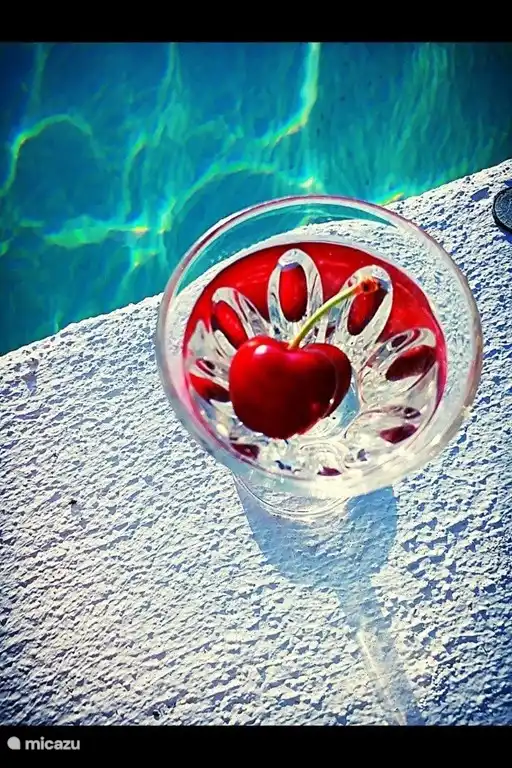 On the edge of the pool, feet in the water....