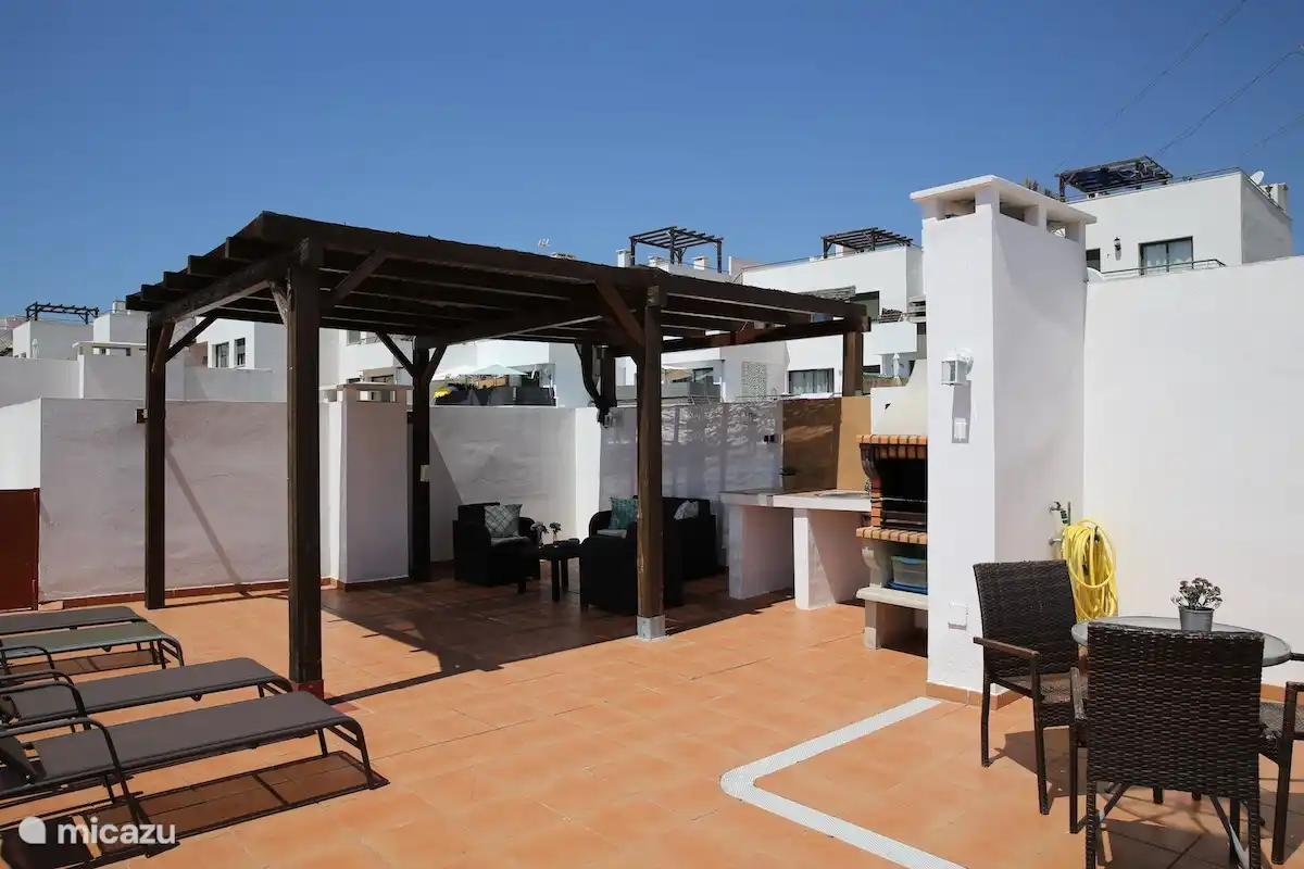 Private roof terrace with pergola and fixed barbecue