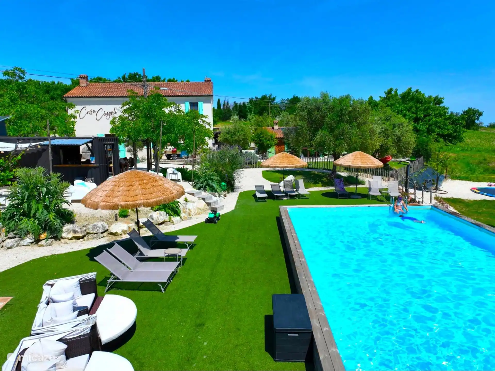 Overzicht casa en zwembad met ligbedden